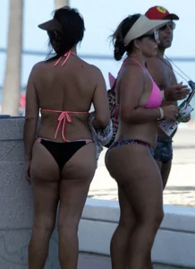 Latina milfs on a beach in Florida in thong bikinis with big booties