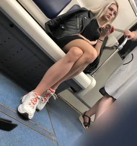 Blonde in a Dress and Sneakers With Sexy Skinny Legs in the Subway Train and on the Escalator Closeup Candid Photos