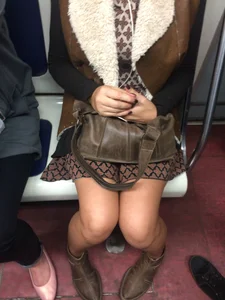 Mom in a Skirt Sitting in a Subway Train Candid