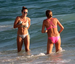 Sexy beach girl in bikini with her other sexy friend