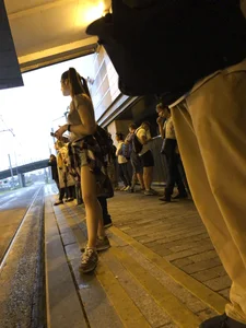 Cute Teen in Shorts on the Tram Stop