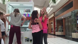 Little blonde teen in grey leggings at the mall with her friends