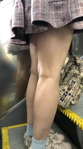 Stocky Girl in a Checkered Skirt on the Escalator Legs Closeup Creepshots