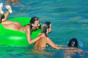 FKK Nudists playing in the water with floater