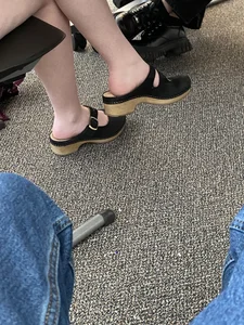 Candid college teen girl's legs and feet in sandals, an under desk closeup creepshot in class