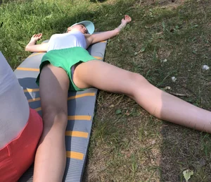 Barefoot Candid Girl in Mini Shorts Lying on the Grass in Nature Park With Spread Legs - Her Panties Sticking Out