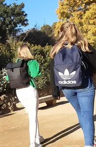 Two beautiful teens in jeans. One white and one blue jeans