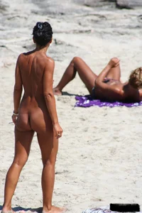 Smoking milf at a nude beach with a hairy pussy