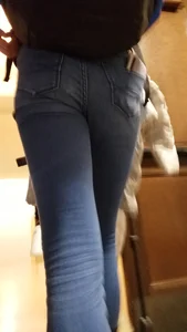 Blonde student in jeans showing her blue thong whale tail