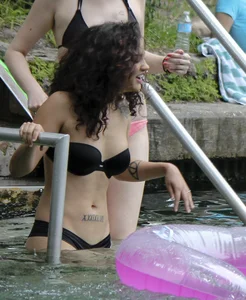 Sexy alt brunette babe in a bikini with piercings and tattoos