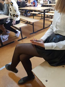 Skinny College Girl in Black Pantyhose Sitting Cross-Legged in Classroom Candid Photo