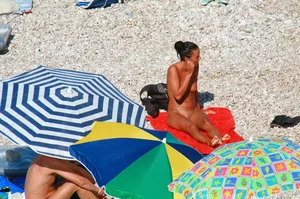 Ula FKK Sexy brunette on a nude beach topless, bottomless and with blue thong