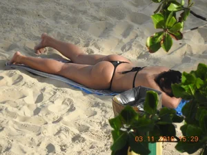 Big booty beach babe laying out in thong