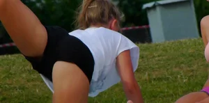 Three sexy girls in bikinis exercising at the park