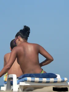 Hot ass topless beach girl with great tits lets her little brother oil up her ass in thong bikini
