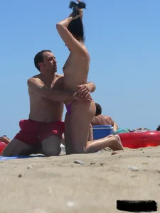 Purple thong topless lady on the beach gets oiled up by her husband