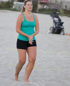 Hot girls playing beach volleyball in bikinis and shorts