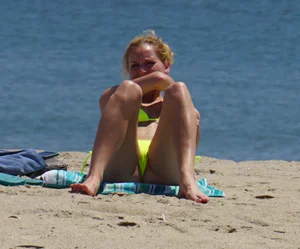 Sexy ass blonde milf on the beach in a thong with cameltoe and bending over