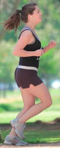 Cute girl running in short shorts
