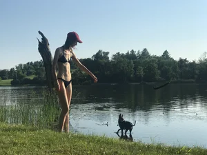 Skinny Girl in Swimsuit with Small Breast on the Shore of a Lake