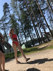 Young Girl in a One-Piece Swimsuit Walking on a Forest Road Photo Gallery
