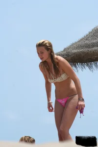 Hot beach girl undressing and going topless