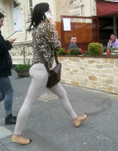 Brunette lady with a nice ass in light grey leggings walking
