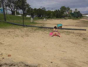 White thong brunette babe laying out on the beach with her dog