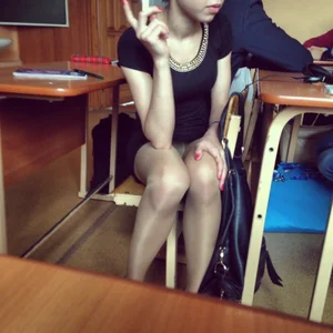 College Girl in Pantyhose and a Skirt Sitting at Her Desk in Classroom Candid Photo