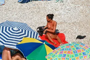Ula FKK Sexy brunette on a nude beach topless, bottomless and with blue thong