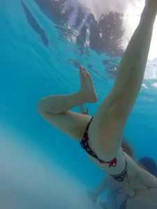 Underwater shots of a bikini teen swimming in the pool