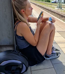 A Hot Candid Girl in Mini-Shorts And Sneakers Sitting on the Floor at the Railway Station Creepshots Gallery