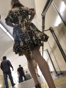 Low angle pics of a candid girl wearing a dress with long and very slim legs
