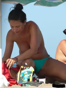 Bunch of sexy babes on the beach topless and in thong bikinis