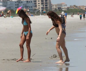 Brunette and redhead on the beach in bikinis looking sexy