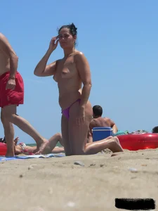 Purple thong topless lady on the beach gets oiled up by her husband