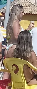 Blonde beach babe in a white and yellow thong bikini