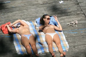 Two teens stripping and going topless to tan