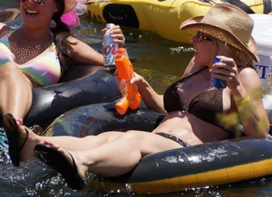 Sexy party girls in bikinis on a lake