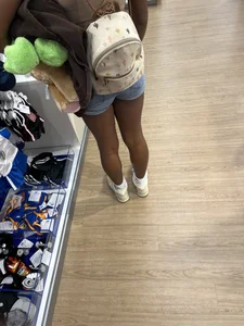 Hot ebony girl in shorts at the store