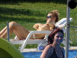 Topless lady at the pool with nice tits