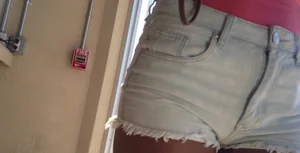 Sexy black girl in short white shorts