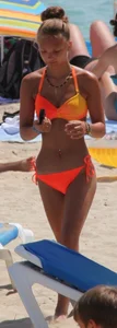 Blonde teen on the beach in orange bikini