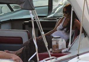 Bikini babe on a boat with a wet see through white shirt showing her tits