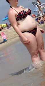 Fat chick with big boobs at the beach in a bikini