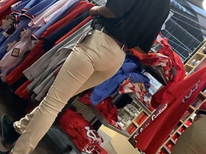 Bunch of girls in various outfits at a Cardinals baseball game