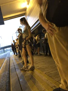 Cute Teen in Shorts on the Tram Stop