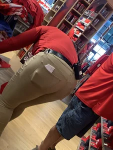 Bunch of girls in various outfits at a Cardinals baseball game