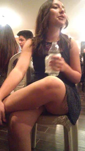 College cutie in a dress sitting with crossed legs