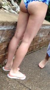 Closeup of a gilrl with hot petite booty in a swimsuit and legs